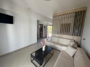 a living room with a couch and a table at Stemma Hotel in Sidari