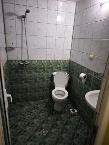 a bathroom with a toilet and a sink at Водстрой in Popovo