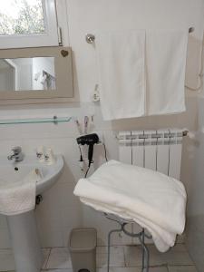 a white bathroom with a sink and a towel at La Bouganville B&B in Sora +23 photos
