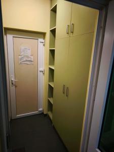 a corridor of a locker room with a door and shelves at Водстрой in Popovo