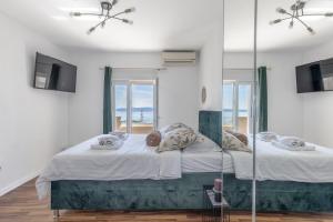 a bedroom with a bed with a view of the ocean at Villa Collis in Makarska +27 photos