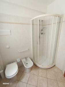 a bathroom with a shower and a toilet at Alba Blu Sampieri in Sampieri +27 photos