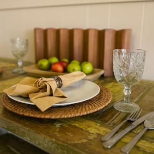 a table with a plate and a glass of wine at Cozy Cottage Centrally Located WorkerFriendly in Sherman