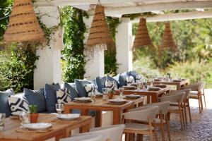 a row of tables and chairs at a restaurant at Octant Vila Monte in Moncarapacho
