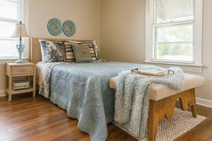 a bedroom with a bed with a blanket on it at Cozy Cottage Centrally Located WorkerFriendly in Sherman