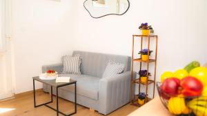 a living room with a couch and a table with balloons at Apartment Eva Hvar in Hvar