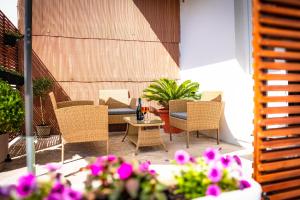 a patio with a table and chairs and flowers at Apartment Eva Hvar in Hvar