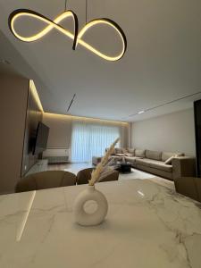 a living room with a couch and a table at Modern Lake Apartment Tirana - Quiet Stay near Liqeni i Thatë in Tirana +5 photos