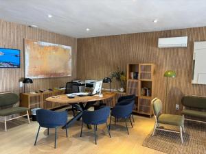 an office with a table with chairs and a computer at Aparthotel Nelva Resort in Cala en Porter