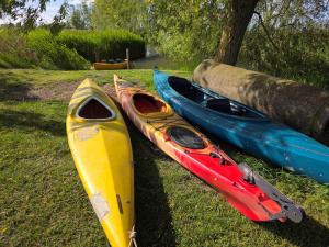 a group of three kayaks sitting on the grass at Holiday Home 't Hof der Witte Damen in Veurne