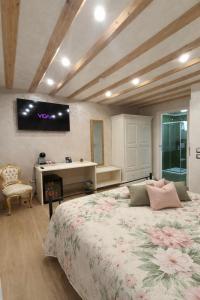 a bedroom with a bed and a tv on the wall at Dal Doge - Guest House in Chioggia