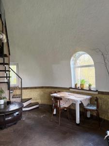 a living room with a table and a window at Kupol for rest in Irpin