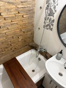 a bathroom with a bath tub and a sink at Kupol for rest in Irpin +77 photos
