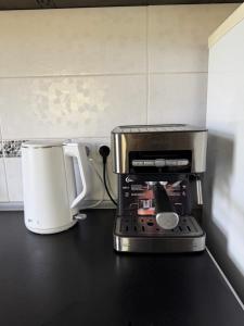 a coffee maker sitting on a counter next to a coffee pot at Kupol for rest in Irpin
