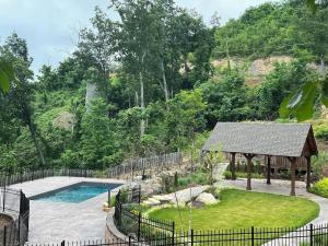a backyard with a swimming pool and a gazebo at Eden's View in Gatlinburg