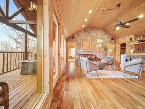 a living room with wooden floors and a wooden ceiling at Eden's View in Gatlinburg