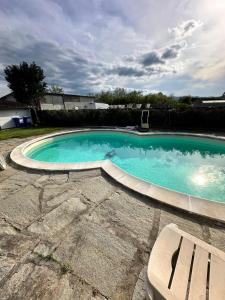a large swimming pool with a bench in a yard at B&B Pizziconi Relax in Podere Modello
