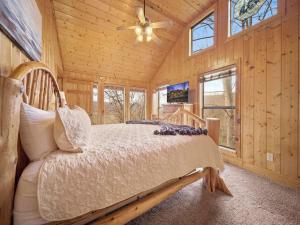 a bedroom with a bed in a wooden cabin at Eden's View in Gatlinburg +30 photos