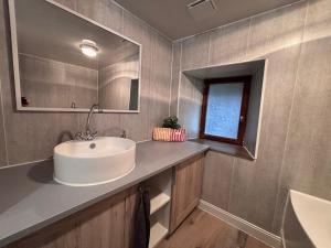 a bathroom with a sink and a mirror at Comme à La Maison in Cayres +21 photos