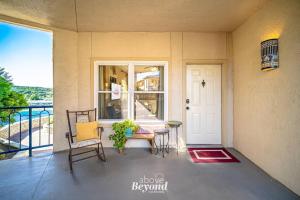 a porch with a table and chairs and a door at Sunset & Lakeview from Castle Turret on The Island in Lago Vista