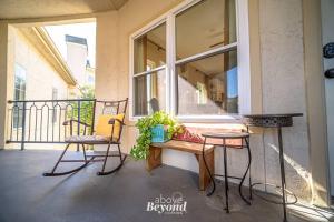 a porch with two chairs and a table and a window at Sunset & Lakeview from Castle Turret on The Island in Lago Vista