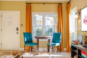 a dining room with a table and blue chairs at Sunset & Lakeview from Castle Turret on The Island in Lago Vista +153 photos