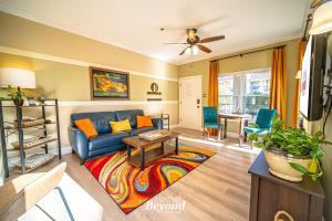 a living room with a blue couch and a table at Sunset & Lakeview from Castle Turret on The Island in Lago Vista