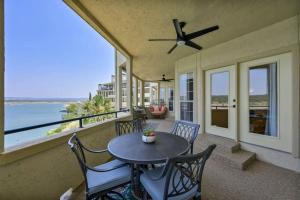 a patio with a table and chairs and the ocean at Pets Stay Free, Breezy, Stylish Island Elegance in Lago Vista