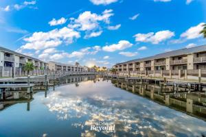 a body of water in front of apartment buildings at The Cobalt Crab Oasis in Rockport