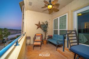 a porch with a blue couch and a fan at Color Pop by the Pool in Lago Vista
