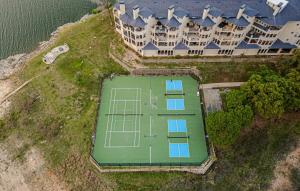 an overhead view of a tennis court in front of a house at Color Pop by the Pool in Lago Vista