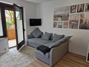 a living room with a couch and a tv at Sleep - See - Nah in Klagenfurt