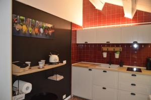 a small kitchen with a sink and red tiles at La Spiga apartment near Venice in Noale +83 photos