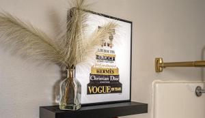 a vase on a shelf with a picture of a bottle of wine at Glam Jam! - Newly Remodeled Stay in Style! Pets Stay Free in Branson