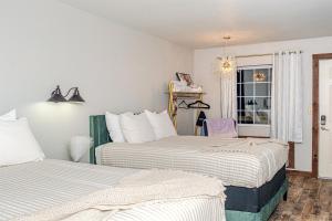 two beds in a room with a window at Glam Jam! - Newly Remodeled Stay in Style! Pets Stay Free in Branson +66 photos