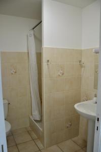 a bathroom with a shower and a toilet and a sink at Maison de plage in Guissény +24 photos