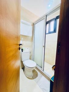 a bathroom with a toilet and a window at Qlbs sweet room in Abidjan +25 photos