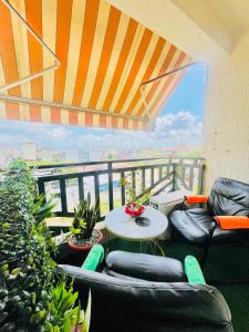a balcony with couches and a table and a view at Qlbs sweet room in Abidjan