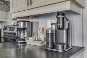 a kitchen with a coffee maker on a counter at INITIAL - CAVALIER - Chutes-Montmorency in Boischâtel