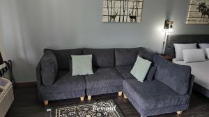 a living room with a couch and a bed at Modern Moose Free Shuttle to SDC in Branson