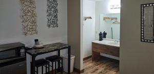 a bathroom with a sink and a counter with a mirror at Modern in the Mountains Free Shuttle to SDC in Branson