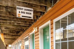 a sign that reads guest laundry and dog wash on a building at Modern in the Mountains Free Shuttle to SDC in Branson