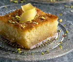 a piece of cake on a glass plate on a table at Βωλίτης Ξενώνας - Παραδοσιακό Καφενείο Ζαγορίου in Papingo