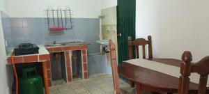 a small kitchen with a sink and a table at Finca la pilarica in Istmina