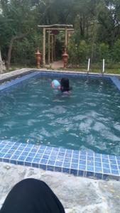 a person swimming in a swimming pool at Lake Forest Holiday Resort in Kataragama +31 photos