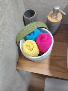 a bowl filled with different colored towels on a table at Staša Apartmani in Novi Pazar +44 photos