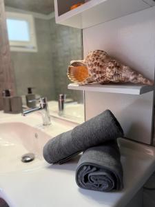 a towel on a bathroom counter next to a sink at La mina's house in Symi