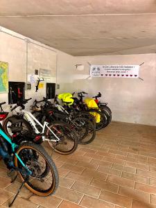 a group of motorcycles parked in a garage at Hotel Le Palme " Adults only " in Grado +46 photos
