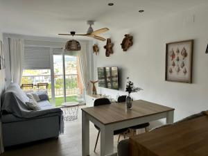 a living room with a table and a couch at Vcc Home’s in Puerto de Mazarrón