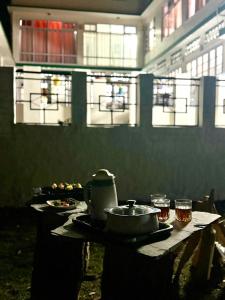 a table with a pot and glasses on it at vishwaram Homestay in Chail